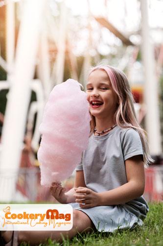 full shot girl holding cotton candy
