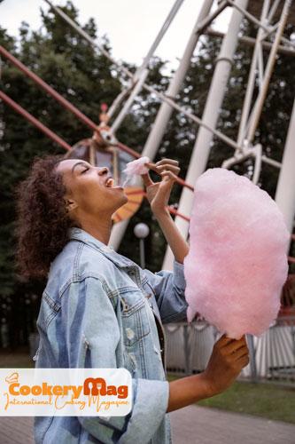 side view woman eating cotton candy