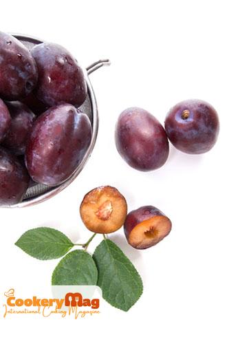 steel colander with sweet juicy plums